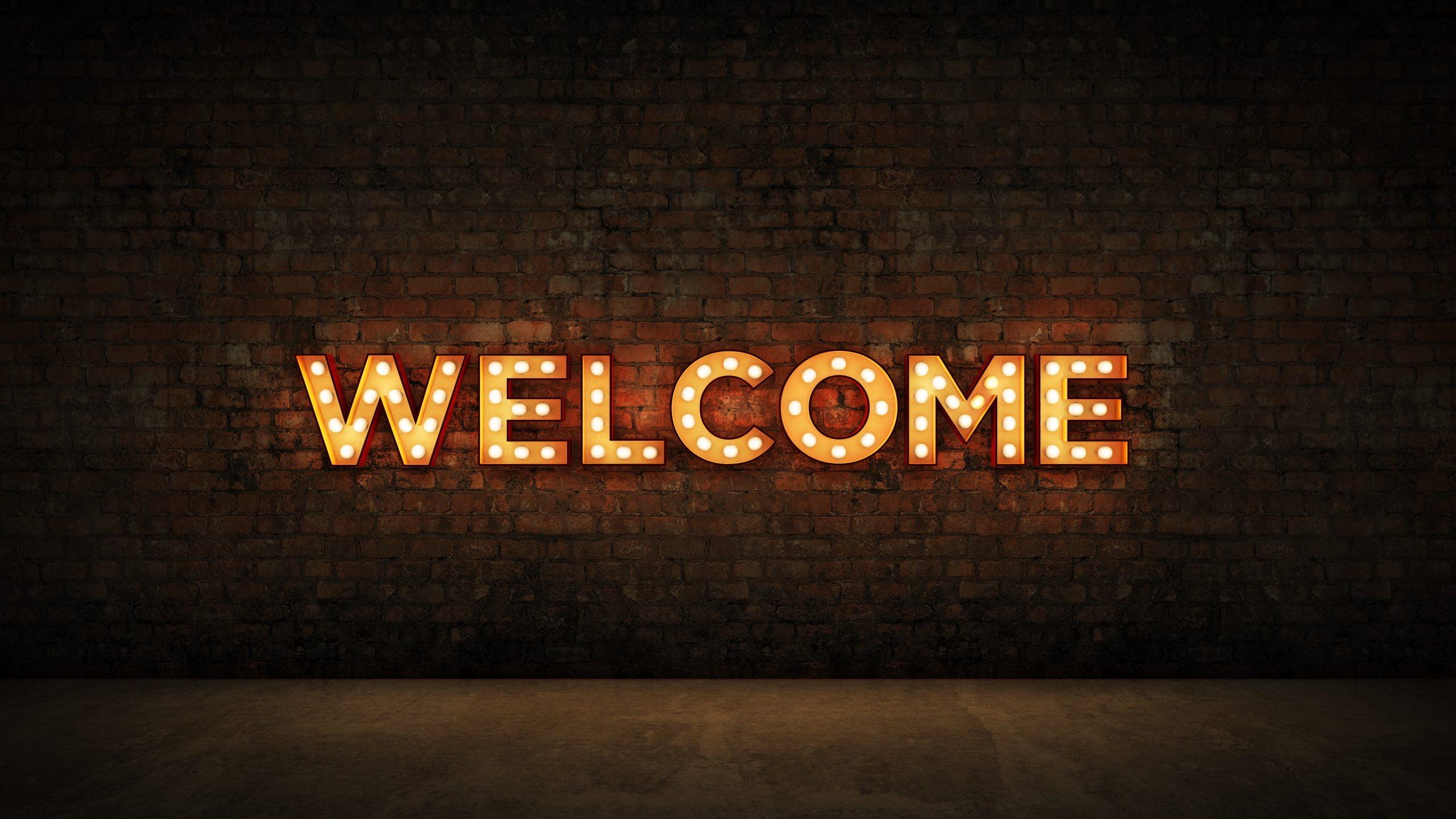 Neon Sign on Brick Wall background – Welcome. 3d rendering